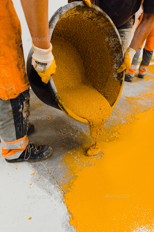 epoxy flooring applicator performs painting works with polyurethane